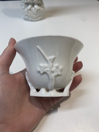 Two Chinese Dehua blanc de Chine wine cups and a figure of Liuhai, 18/19th C.