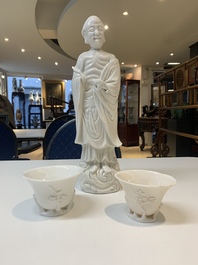 Two Chinese Dehua blanc de Chine wine cups and a figure of Liuhai, 18/19th C.