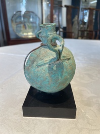 A bronze urn, a bronze canteen with relief design and a pair of bronze oil lamps, Etruscan and Roman civilizations, 9th C. B.C/5th C.