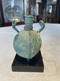 A bronze urn, a bronze canteen with relief design and a pair of bronze oil lamps, Etruscan and Roman civilizations, 9th C. B.C/5th C.