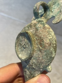 A bronze urn, a bronze canteen with relief design and a pair of bronze oil lamps, Etruscan and Roman civilizations, 9th C. B.C/5th C.