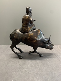 A Japanese gold-splashed bronze incense burner in the shape of an immortal riding a buffalo, ​​Kin San Sō On 金産宗音製造 mark, Meiji, 19th C.