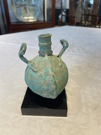 A bronze urn, a bronze canteen with relief design and a pair of bronze oil lamps, Etruscan and Roman civilizations, 9th C. B.C/5th C.