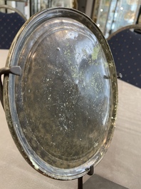 A bronze mirror, a bracelet with a royal or noble emblem and a bronze bracelet with two tiger heads, Cambodia, 12th C.