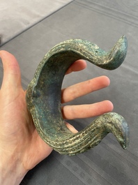 A bronze mirror, a bracelet with a royal or noble emblem and a bronze bracelet with two tiger heads, Cambodia, 12th C.