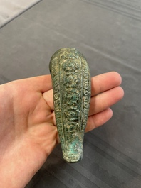 A bronze mirror, a bracelet with a royal or noble emblem and a bronze bracelet with two tiger heads, Cambodia, 12th C.
