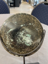 A bronze mirror, a bracelet with a royal or noble emblem and a bronze bracelet with two tiger heads, Cambodia, 12th C.