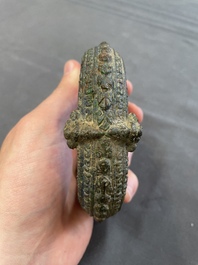 A bronze mirror, a bracelet with a royal or noble emblem and a bronze bracelet with two tiger heads, Cambodia, 12th C.