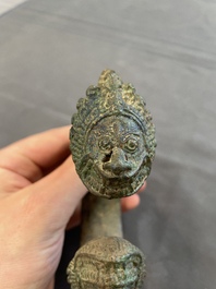 A bronze mirror, a bracelet with a royal or noble emblem and a bronze bracelet with two tiger heads, Cambodia, 12th C.