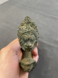 A bronze mirror, a bracelet with a royal or noble emblem and a bronze bracelet with two tiger heads, Cambodia, 12th C.