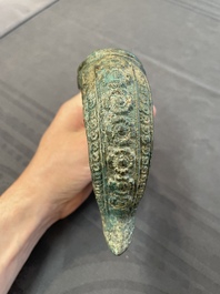 A bronze mirror, a bracelet with a royal or noble emblem and a bronze bracelet with two tiger heads, Cambodia, 12th C.