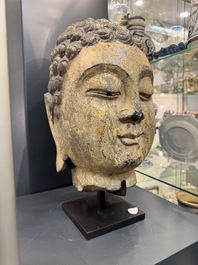 A large Chinese carved stone head of Buddha with traces of gilding and polychromy, Ming