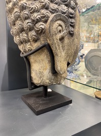 A large Chinese carved stone head of Buddha with traces of gilding and polychromy, Ming
