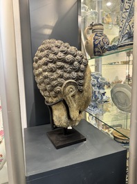 A large Chinese carved stone head of Buddha with traces of gilding and polychromy, Ming