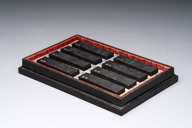 A set of eight Chinese 'Yu Zhi Min Sheng Zai Qin Shi 御製民生在勤詩' ink cakes with a gilt-lacquered 'dragon' box, Hu Kaiwen 胡開文 mark, 20th C.