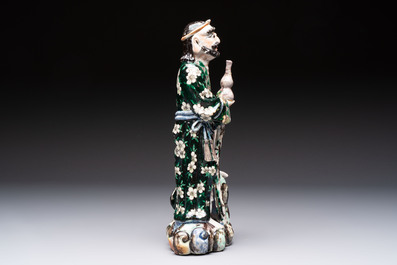 A pair of Chinese famille verte covered jars, a Tieguai Li figure, a blue and white teapot and a biscuit saucer, Kangxi and Qing Yu Tang mark, 19th C.