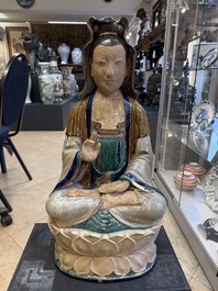 A large Chinese polychrome-glazed Shiwan stoneware figure of Guanyin, 19th C.