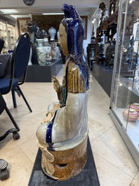 A large Chinese polychrome-glazed Shiwan stoneware figure of Guanyin, 19th C.