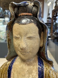 A large Chinese polychrome-glazed Shiwan stoneware figure of Guanyin, 19th C.