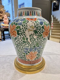 A Chinese wucai 'He He Er Xian' vase on gilt-bronze stand, 19th C.