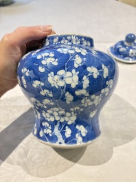 Two pairs of Chinese blue and white covered vases and a large covered vase, 19th C.