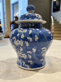 Two pairs of Chinese blue and white covered vases and a large covered vase, 19th C.
