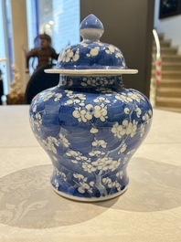 Two pairs of Chinese blue and white covered vases and a large covered vase, 19th C.