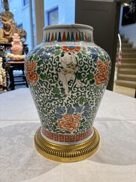 A Chinese wucai 'He He Er Xian' vase on gilt-bronze stand, 19th C.