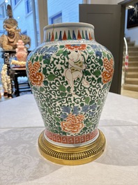 A Chinese wucai 'He He Er Xian' vase on gilt-bronze stand, 19th C.
