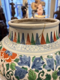 A Chinese wucai 'He He Er Xian' vase on gilt-bronze stand, 19th C.