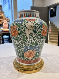 A Chinese wucai 'He He Er Xian' vase on gilt-bronze stand, 19th C.