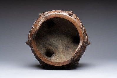 A rare Chinese bronze tripod censer with relief mythical animal and grape design, Xuande mark, 19th C.