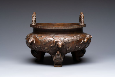 A rare Chinese bronze tripod censer with relief mythical animal and grape design, Xuande mark, 19th C.