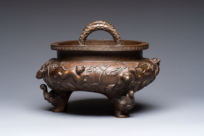A rare Chinese bronze tripod censer with relief mythical animal and grape design, Xuande mark, 19th C.