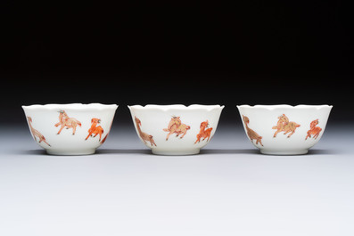 Three fine Chinese eggshell iron-red and gilt-decorated 'Boy and Goats' cups and saucers, Yongzheng