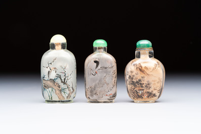 A Chinese rock crystal and two glass inside painted snuff bottles, 19/20th C., with a signed copy of 'Chinese Inside Painting of the Modern Age', 2005
