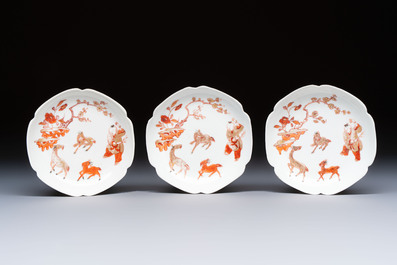 Three fine Chinese eggshell iron-red and gilt-decorated 'Boy and Goats' cups and saucers, Yongzheng