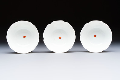 Three fine Chinese eggshell iron-red and gilt-decorated 'Boy and Goats' cups and saucers, Yongzheng