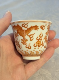 A Chinese iron-red decorated blue and white 'Dragon' saucer and a cup, Yongzheng and Tongzhi mark, 19/20th C.