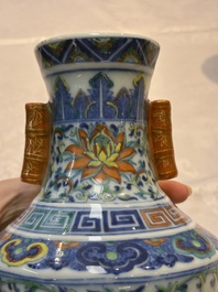 A pair of Chinese doucai 'Hu' vases with lotus scroll design, Qianlong mark, 19th C.