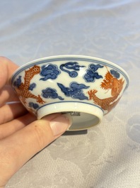 A Chinese iron-red decorated blue and white 'Dragon' saucer and a cup, Yongzheng and Tongzhi mark, 19/20th C.