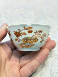 Three fine Chinese eggshell iron-red and gilt-decorated 'Boy and Goats' cups and saucers, Yongzheng