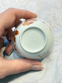 Three fine Chinese eggshell iron-red and gilt-decorated 'Boy and Goats' cups and saucers, Yongzheng