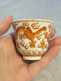 A Chinese iron-red decorated blue and white 'Dragon' saucer and a cup, Yongzheng and Tongzhi mark, 19/20th C.