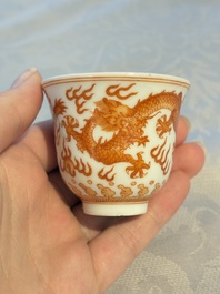 A Chinese iron-red decorated blue and white 'Dragon' saucer and a cup, Yongzheng and Tongzhi mark, 19/20th C.