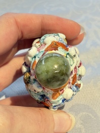 Four Chinese famille rose moulded 'Luohan' snuff bottles, Qianlong marks, 19th C.