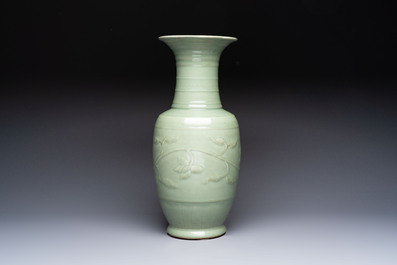 A Chinese celadon-glazed vase with relief lotus scroll design, 18th C.