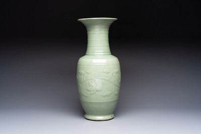 A Chinese celadon-glazed vase with relief lotus scroll design, 18th C.