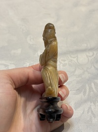 A Chinese carved mother-of-pearl figure of an official on wooden stand, 18/19th C.