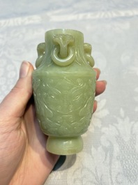 A Chinese celadon jade covered vase, with wooden stand, and a bowl with wooden cover and stand, 19/20th C.